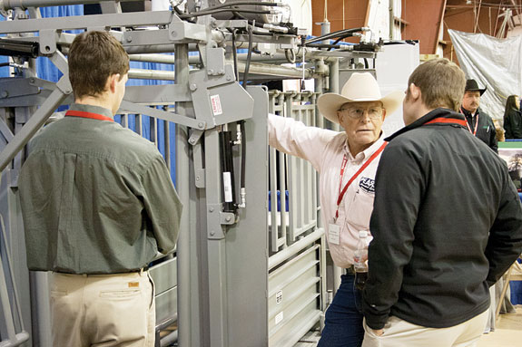 Conference attendees discuss a cattle squeeze