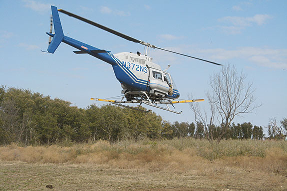 North Star Helicopter broadcasting fire ant bait on central Texas beef cattle ranch