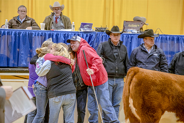 hug at cattle auction